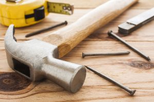 a hammer and a pair of pliers on a table.