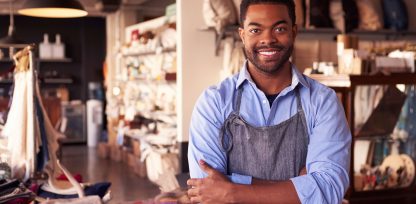 a man standing in a store with his arms crossed.