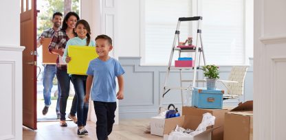 a group of people walking through a house.